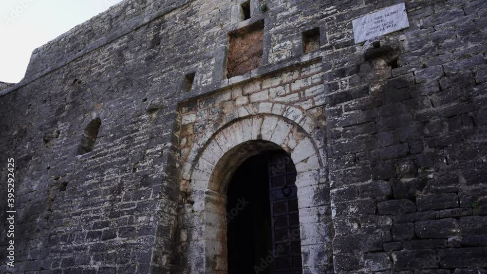 Fortress entrance with stone walls and arc gate of Medieval castle in Albania Fortress entrance with stone walls and arc gate of Medieval castle in Albania