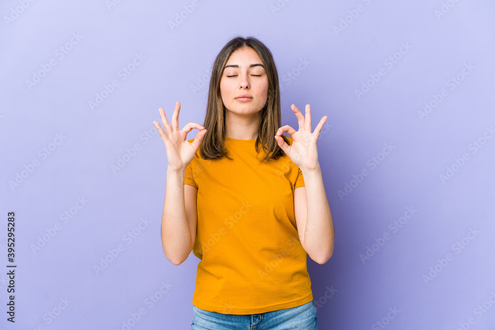 Young caucasian woman relaxes after hard working day, she is performing yoga. Young caucasian woman relaxes after hard working day, she is performing yoga.