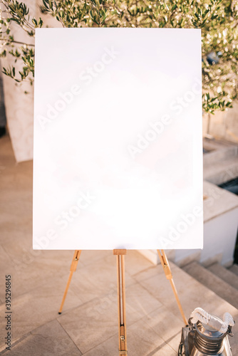 Wooden easel with white paper Fototapet