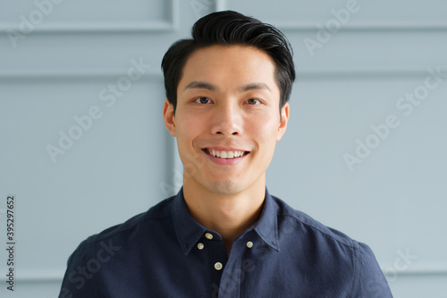 Portrait young confident smart Asian businessman look at camera and smile photo