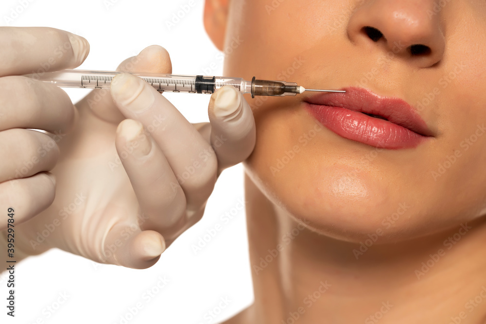 Portrait of a young beautiful woman on a lip filler injection procedure