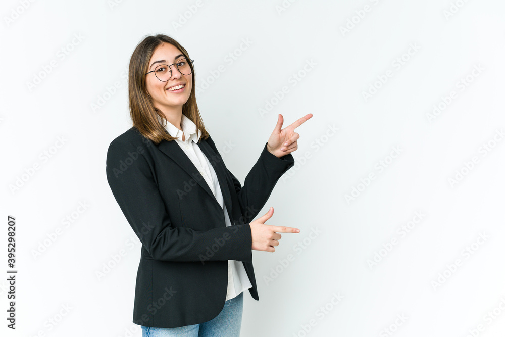 Young caucasian business woman excited pointing with forefingers away. Young caucasian business woman excited pointing with forefingers away.