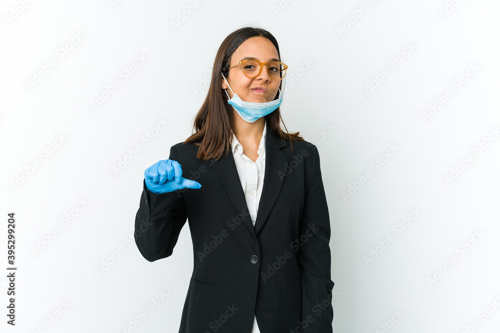Young business latin woman wearing a mask to protect from covid isolated on white background showing a dislike gesture, thumbs down. Disagreement concept. Young business latin woman wearing a mask to protect from covid isolated on white background showing a dislike gesture, thumbs down. Disagreement concept.