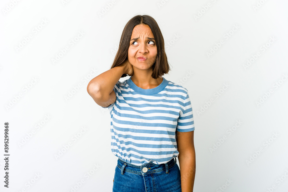 Young mixed race woman touching back of head, thinking and making a choice. Young mixed race woman touching back of head, thinking and making a choice.