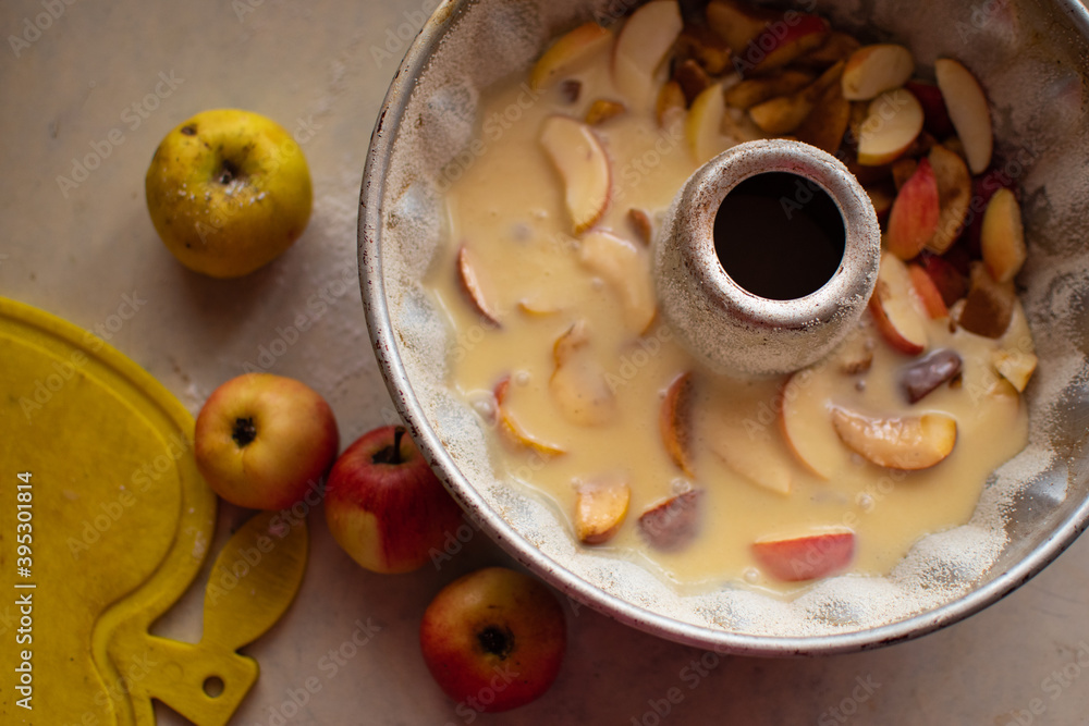 Tasty apple pie preparation in progress; process or recipe for cooking with ingredients and kitchen utensils