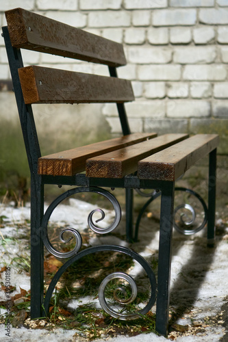 old bench on a patch of unmelted first snow