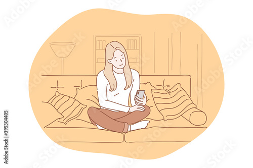 Smartphone, online communication, chatting concept. Young girl sitting at home with smartphone in hands, chatting, searching information in internet, calling, dating or communicating online 