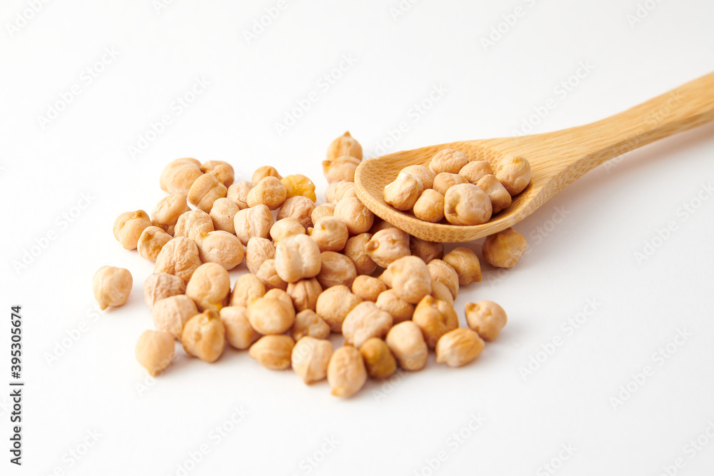 A pile of chickpeas on a wooden spoon A pile of chickpeas on a wooden spoon