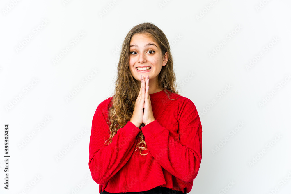 Young caucasian woman holding hands in pray near mouth, feels confident. Young caucasian woman holding hands in pray near mouth, feels confident.