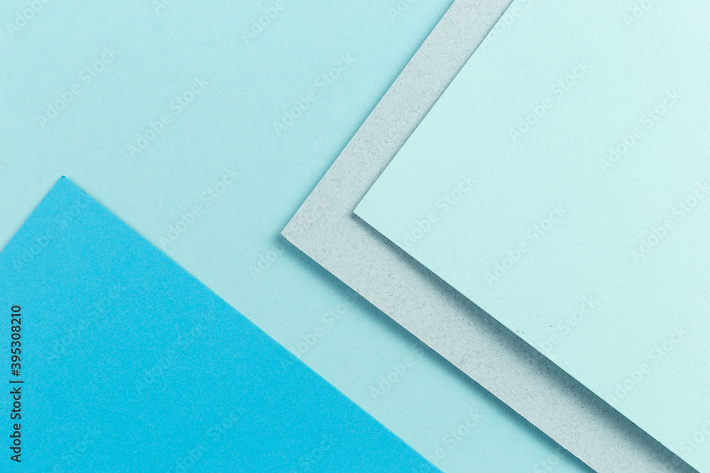 Material design blue background. Craft paper sheets are folded in different ways. A photo. Material design blue background. Craft paper sheets are folded in different ways. A photo.
