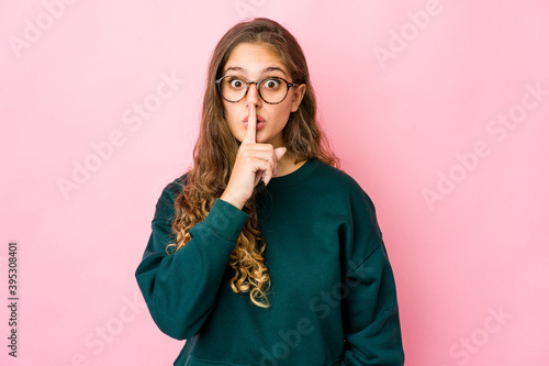 Young caucasian woman keeping a secret or asking for silence.