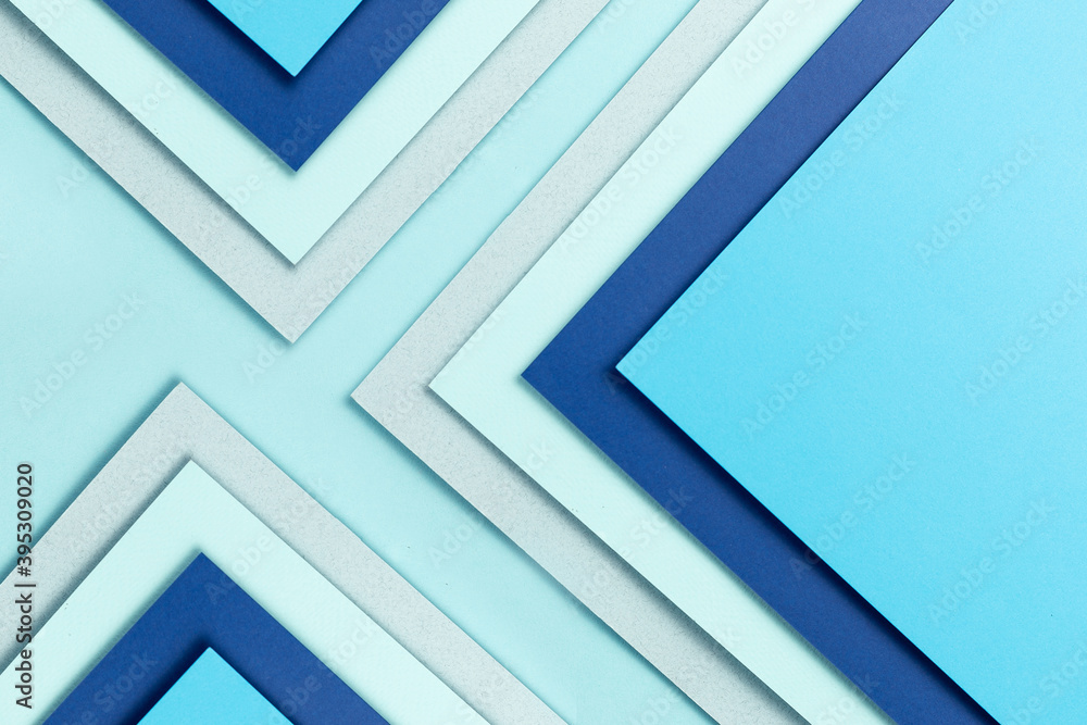 Material design blue background. Craft paper sheets are folded in different ways. A photo. Material design blue background. Craft paper sheets are folded in different ways. A photo.