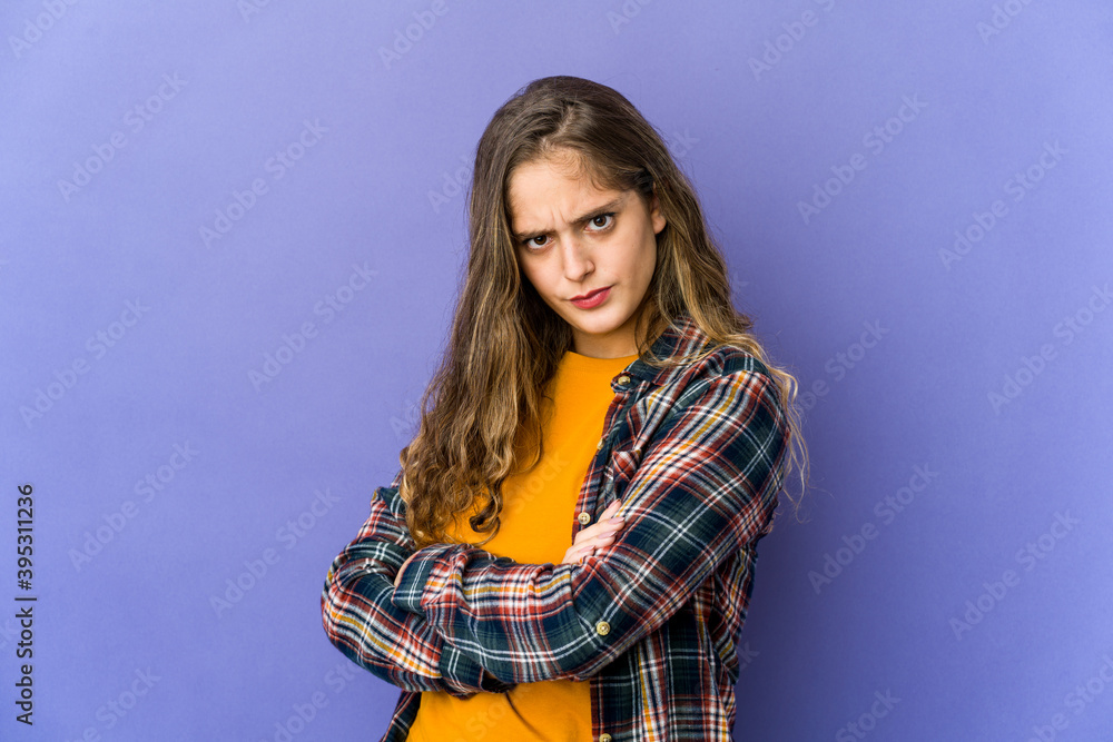 Young caucasian cute woman frowning face in displeasure, keeps arms folded. Young caucasian cute woman frowning face in displeasure, keeps arms folded.