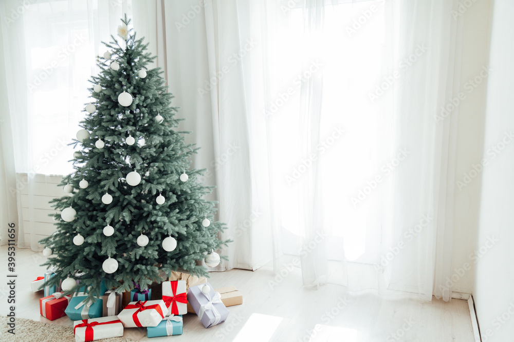 New Year's decoration Christmas tree with gifts and garlands interior New Year's decoration Christmas tree with gifts and garlands interior