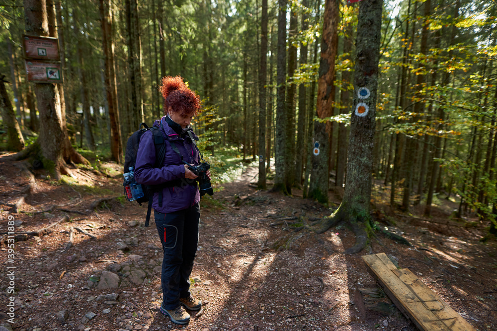 Fototapeta premium Tourist lady with camera hiking