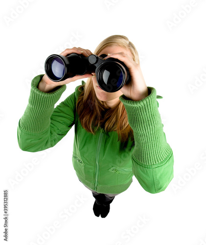 Studio photo of young woman wearing a green jacket, looking in binoculars. Photo from above. Isolated on white background.