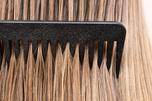 closeup of blonde hair with a comb running through it