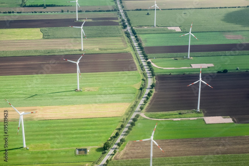 Aerial view of wind turbines along a rural road photo