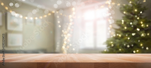 Obraz na płótnie A wood table, tabletop product display with a festive living room Christmas background of Christmas tree and fairy lights. w salonie