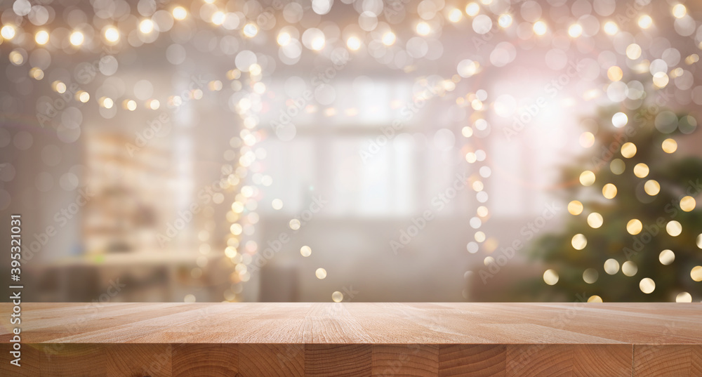 A wood table, tabletop product display with a festive Christmas background of Christmas tree and fairy lights.