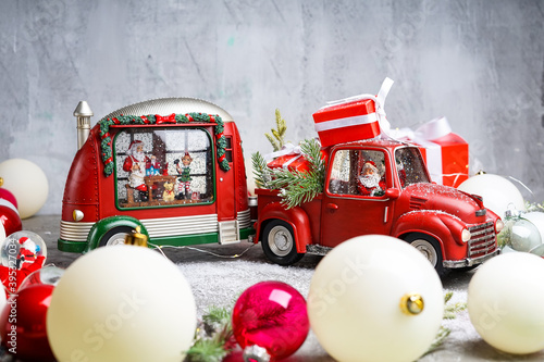 Fotografija christmas mockup red car with gifts and trailer trailer with santa claus driving