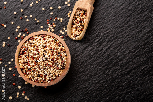 Obraz na płótnie mixed three varieties of raw quinoa, South American grain on a stone background