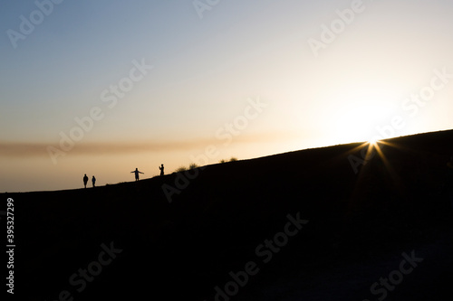 Sicily, Italy. A small group of tourists explore the rim of the Silvestri Inferiore crater near the summit of Mt Etna. © Dave