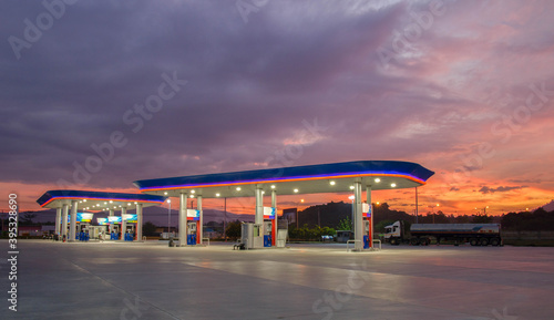 Gas station at sunrise and orange sky . photo