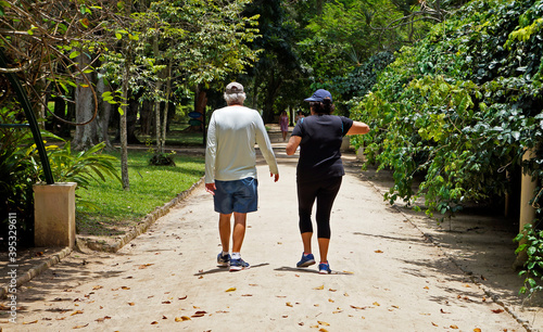 Elderly couple walking on trail in public park, Rio de Janeiro