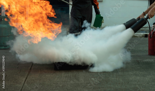 Man teaches or training how to use carbon dioxide (CO2) fire extinguishers to extinguish fires from fuel.