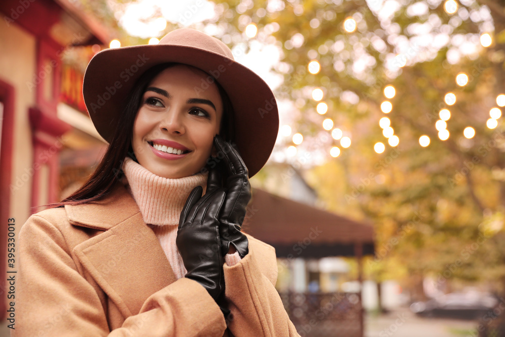 Young woman wearing stylish clothes on city street, space for text. Autumn look Young woman wearing stylish clothes on city street, space for text. Autumn look