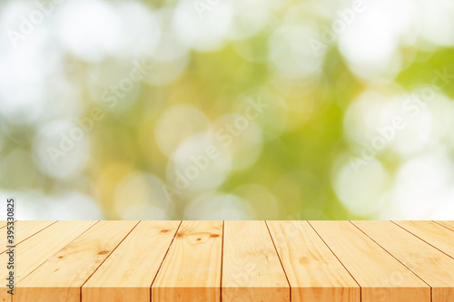 wooden table on nature green bokeh background.