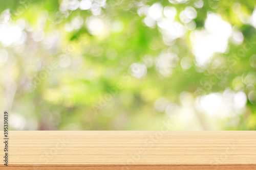 wooden table on nature green bokeh background.