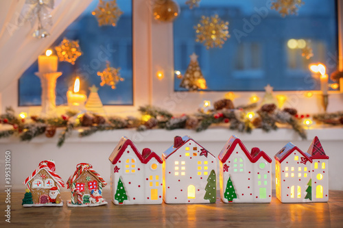Christmas toy houses on  background of  decorated window