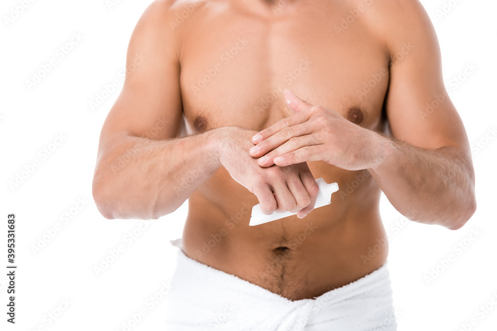 cropped view of shirtless man in towel applying hand cream isolated on white cropped view of shirtless man in towel applying hand cream isolated on white