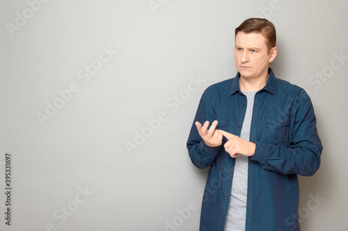 Portrait of serious man making list of something with fingers