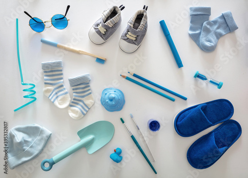 Fototapeta Naklejka Na Ścianę i Meble -  Baby boy blue color accessories on white background, top view.