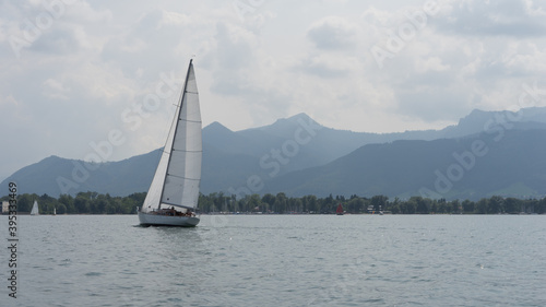 Chiemsee, Germany - August 25, 2019: sailboats on the lake "Chiemsee", in the background the mountains "Alps"