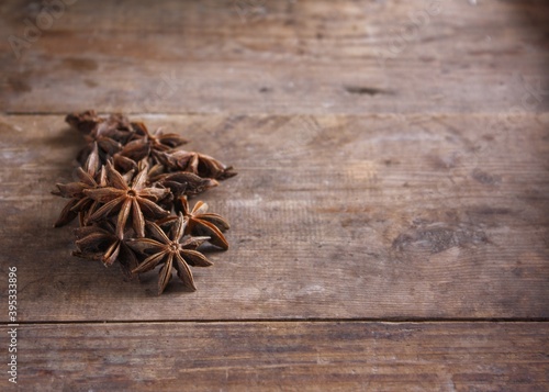 Anise stars on a wooden background witn copy space