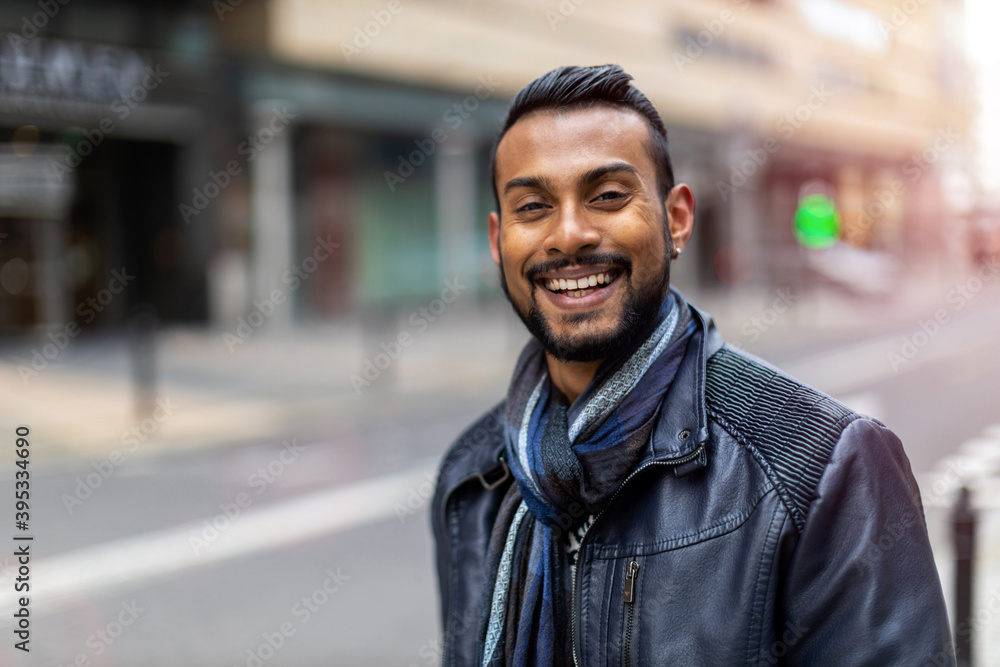 Fototapeta premium Portrait of a handsome young man on the city street 