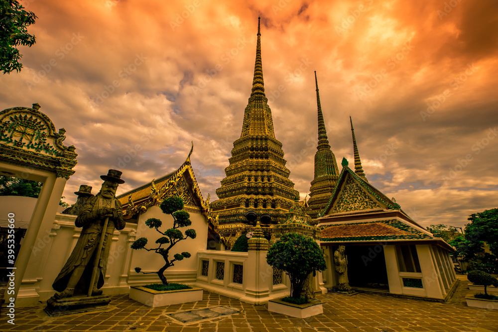 Fototapeta premium background of important religious attractions in Bangkok (Wat Phra Chetuphon (Wat Pho - reclining Buddha), a large pagoda and beautiful sculptural art give future generations to explore its history