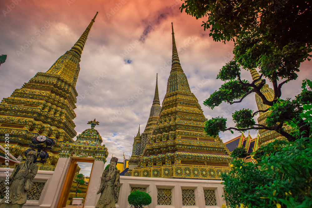 Fototapeta premium background of important religious attractions in Bangkok (Wat Phra Chetuphon (Wat Pho - reclining Buddha), a large pagoda and beautiful sculptural art give future generations to explore its history