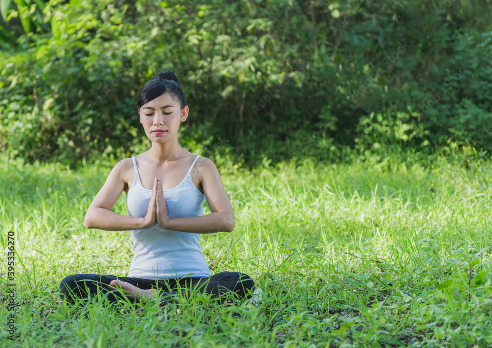 Young women Sitting doing yoga to relax . practice meditation to care wellness outdoor