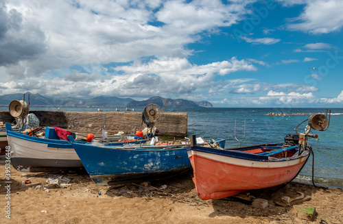 Multicolored fishing boats on the beach. Aspra, Sicily, Italy.