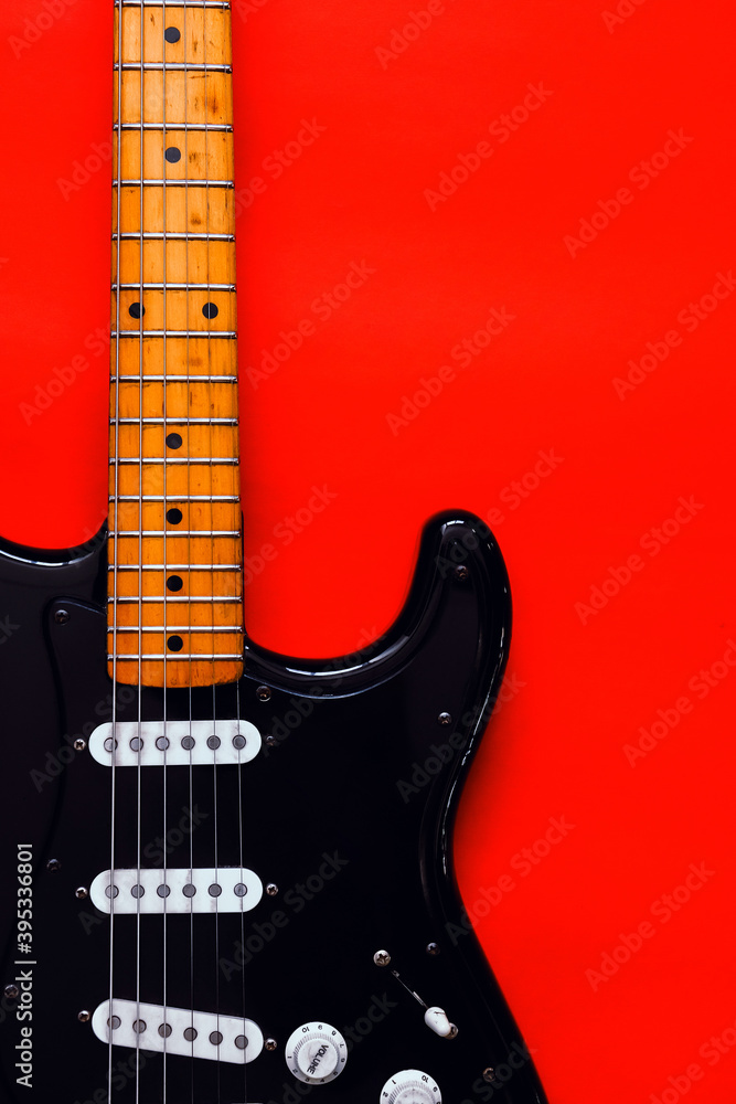 Obraz premium Detail of Electric Guitar on a red background.