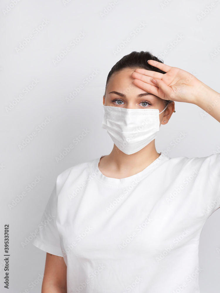 Young woman wearing a mask checking body temperature Young woman wearing a mask checking body temperature