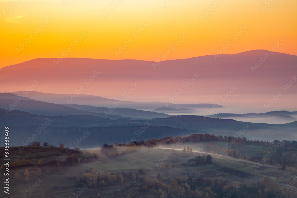 Obraz premium dawn in the mountains fog between the hills.