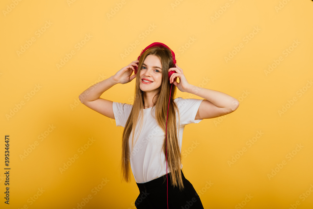 Isolated portrait of happy woman stands over yellow wall. Positive emotions and feelings concept Isolated portrait of happy woman stands over yellow wall. Positive emotions and feelings concept