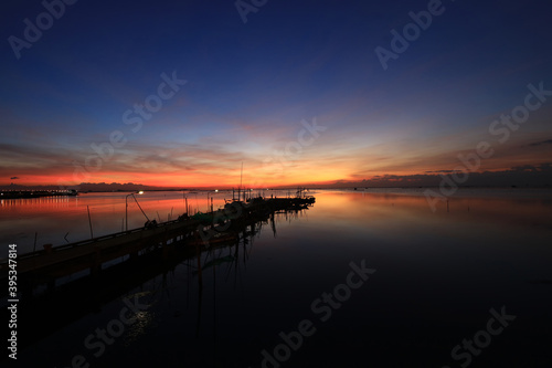 Fishing port or local port againt twiligh sky during sunset or sunrist at Chonburi, Thailand, Dramatic sunset sky