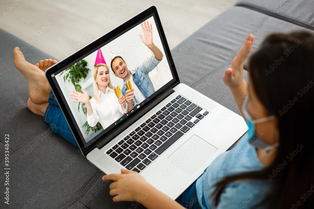 couple waving while having a videocall in santa hats on laptop at home. social distancing during christmas festivity quarantine lockdown concept. couple waving while having a videocall in santa hats on laptop at home. social distancing during christmas festivity quarantine lockdown concept.